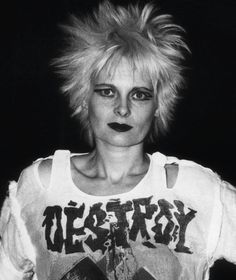 a black and white photo of a woman with blonde hair wearing a t - shirt