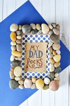 a photo frame made out of rocks with the words my dad rocks frame on it