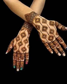 two hands with henna designs on them