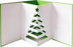 an open card with a christmas tree cut out of it's side and green trim