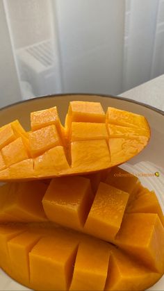 slices of mango sitting on top of a white plate