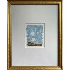 a painting hanging on the wall in a gold frame with a blue sky and clouds