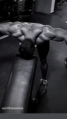 a man doing push ups on a bench in a gym