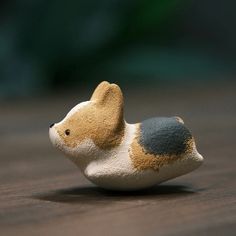 a small toy dog sitting on top of a wooden table