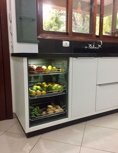 an open refrigerator filled with lots of fruit and veggies on the counter top