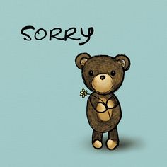 a brown teddy bear standing next to the word sorry