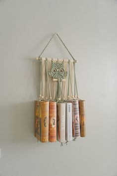 books are hanging on the wall with an owl decoration