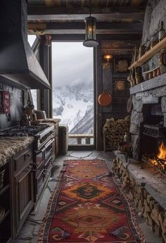a kitchen with an open door leading to a snowy mountain range in the distance, and a rug on the floor