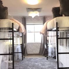 bunk beds in a dorm room with sheer curtains