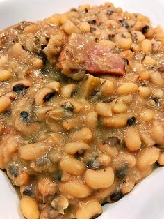 a white plate topped with beans and meat