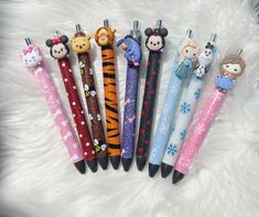 several pens are lined up in the shape of cartoon animals and panda, snowflakes