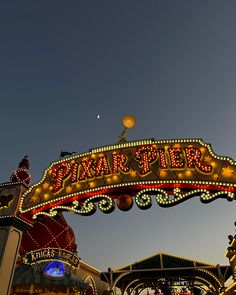 an amusement park sign with lights on it's sides and the name sparkler