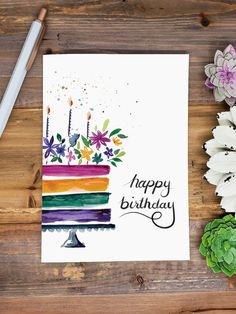 a birthday card with flowers and a cake