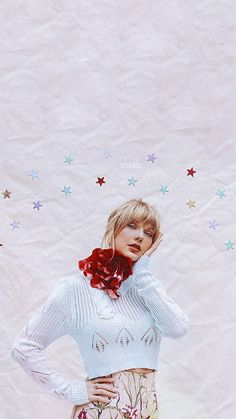 a woman standing in front of a wall with stars on it