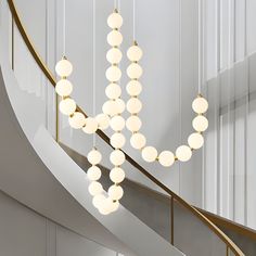 a chandelier hanging from the side of a staircase