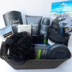 a black basket filled with men's grooming products and hair care items on top of a white table