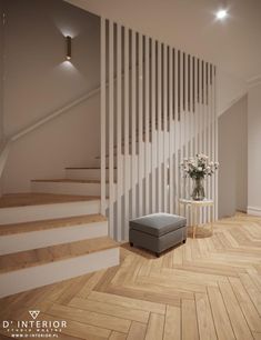 a living room with wooden floors and white railings on the wall next to a gray ottoman