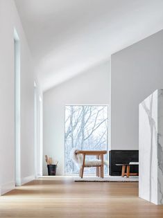 a living room with white walls and wood floors