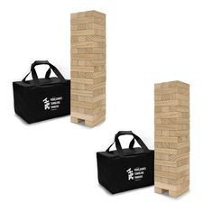 three wooden blocks stacked on top of each other in front of a black tote bag