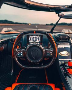 the interior of an orange and black sports car