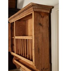 an old wooden bookcase in the corner of a room