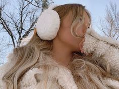 a woman with ear muffs on her head