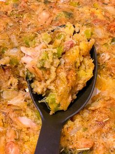 a close up of food on a pan with a spatula in the foreground