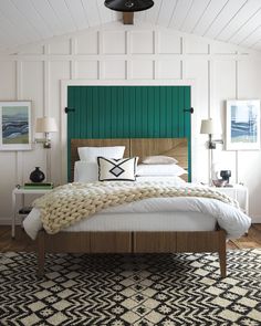 a bedroom with white walls and green headboard, black and white rug on the floor