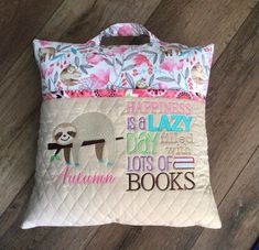 a pillow with a slotty on it and the words happiness is a lazy day like lots of books