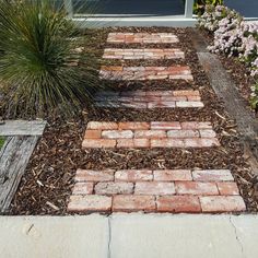 a brick pathway in front of a house