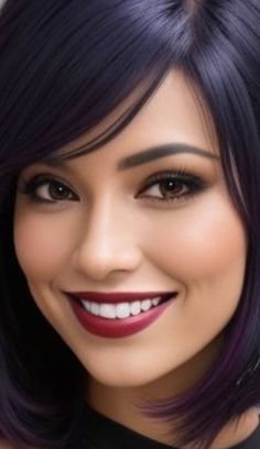 a woman with purple hair and black dress smiling at the camera while wearing red lipstick