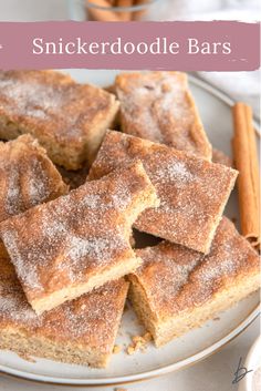 some sugared brownies on a white plate with cinnamon sticks in the background and text overlay that reads, snickkerdoodlele bars