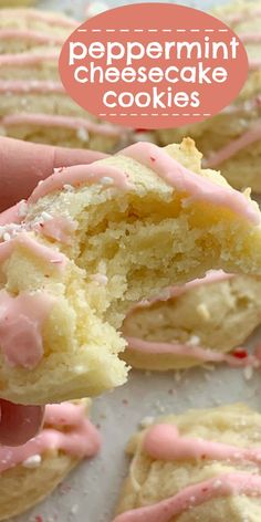 a close up of a person holding a doughnut with pink frosting on it