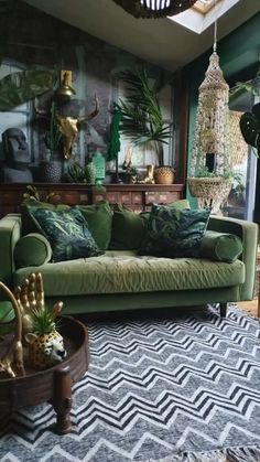 a living room filled with green furniture and lots of plants on top of the walls