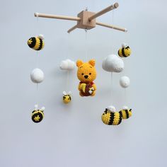 a crocheted teddy bear and bees mobile