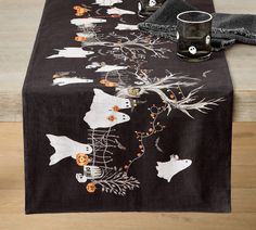 a black table runner with halloween decorations on it