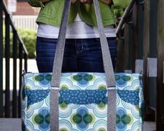 a woman carrying a large blue and green bag