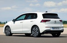 the rear end of a white vw golf gti parked in an empty lot