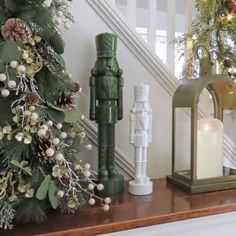 christmas decorations and candles on a mantle in front of the bannister with pine cones