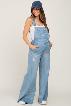 A pair of light washed denim maternity overalls featuring adjustable straps, side buttons, side pockets, belt loops, two back pockets and a wide pant leg with raw hem detailing. The Blue Light Wash Denim Distressed Wide Leg Maternity Overalls is perfectly bump-friendly! Maternity Jean Overalls, Pregnancy Overall Outfits, Maternity Overalls Outfit, Maternity Outfits For Photoshoot, Denim Baby Shower, Maternity Dungarees, Baby Shower Outfit Ideas, Family Maternity Pictures, Maternity Overalls