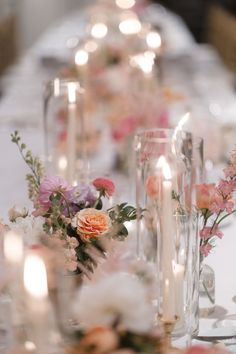 a long table with candles and flowers on it