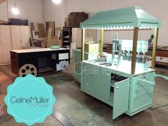 an old fashioned ice cream cart in a warehouse with boxes and other items on the floor
