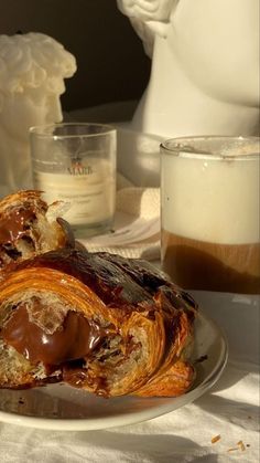 a pastry on a plate next to a cup of coffee