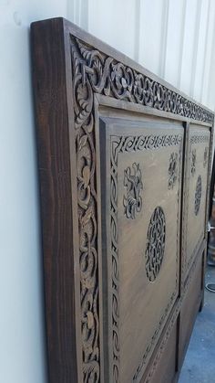 an old wooden bed with intricate carvings on it