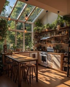 a kitchen filled with lots of windows next to a stove top oven and wooden table