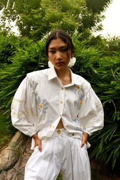 Statement shirt made in 100% cotton poplin featuring cross-stitch embroidery and big puffed sleeves with crochet lace inserts. Pair with trousers from this beautiful floral collection or just a pair of jeans to complete the look. Each one is made to order in handwoven cotton and is hand embroidered to perfection. Customisations: We are able to customise the fit, size, or length of this piece for you. Please email us at hello@ominana.com to see how we can help. Pre-order info: This piece will be Cotton Poplin Top, Beaded Shirt, Hand Beaded Embroidery, Poplin Top, Floral Collection, Statement Shirt, Shirt Embroidery, Handmade Brass, Lace Insert