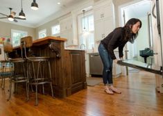 a woman standing in the middle of a kitchen