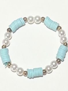 a bracelet with pearls and glass beads on a white background, the bead is light blue