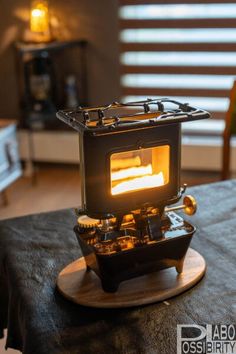an old fashioned stove sitting on top of a table