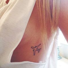 a woman with a small airplane tattoo on her back
